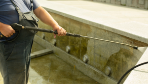 someone cleaning mold from a wall